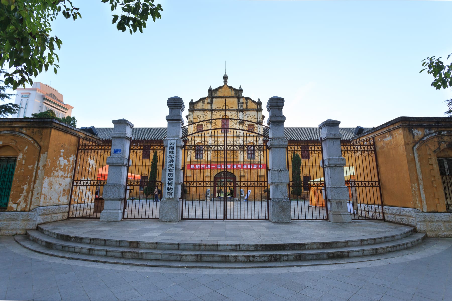 The gate and yellow facade of the Yunnan Military Academy museum on Green Lake's west shore