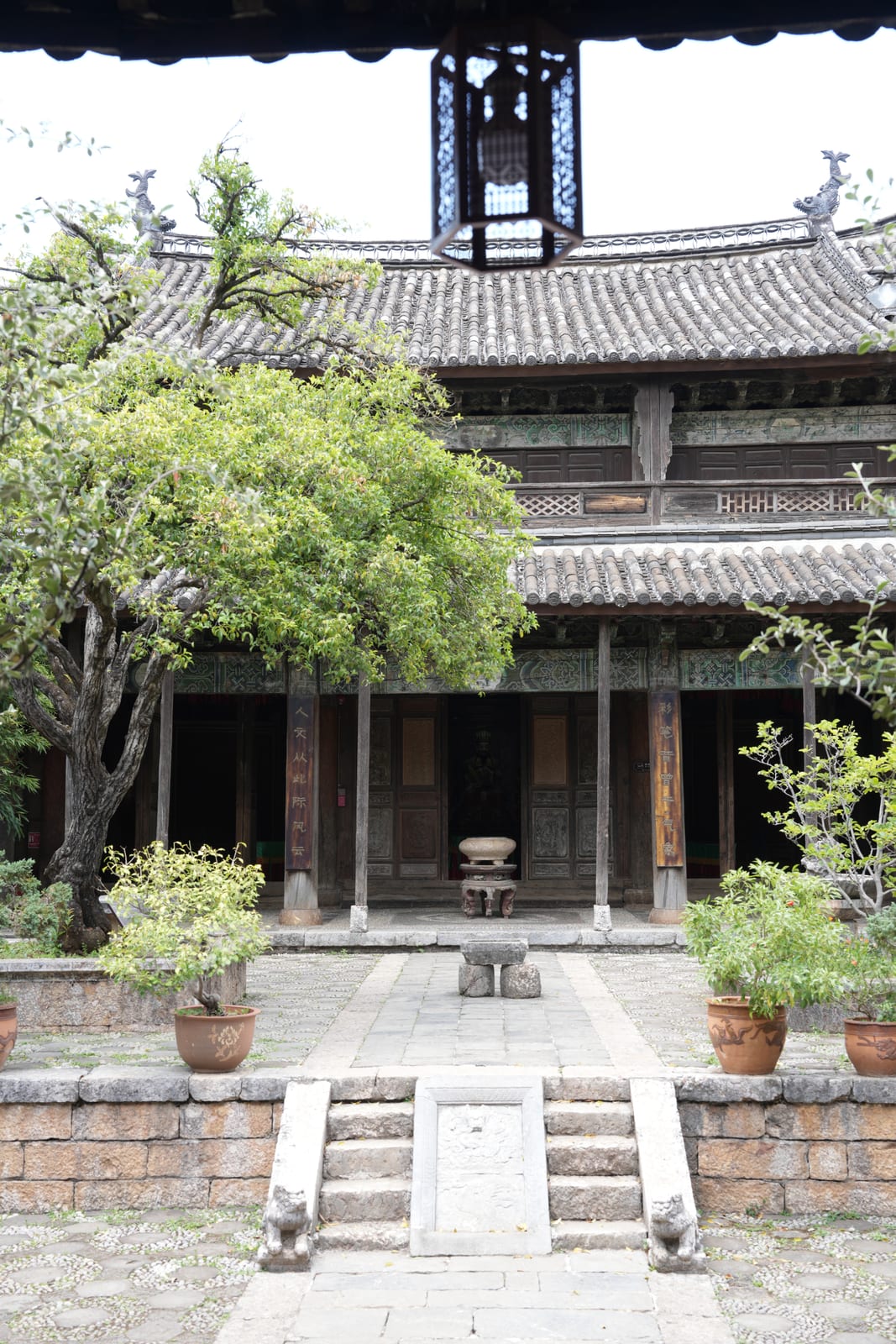 The Mu Palace courtyard in Lijiang's Dayan old town, carved Naxi timber architecture