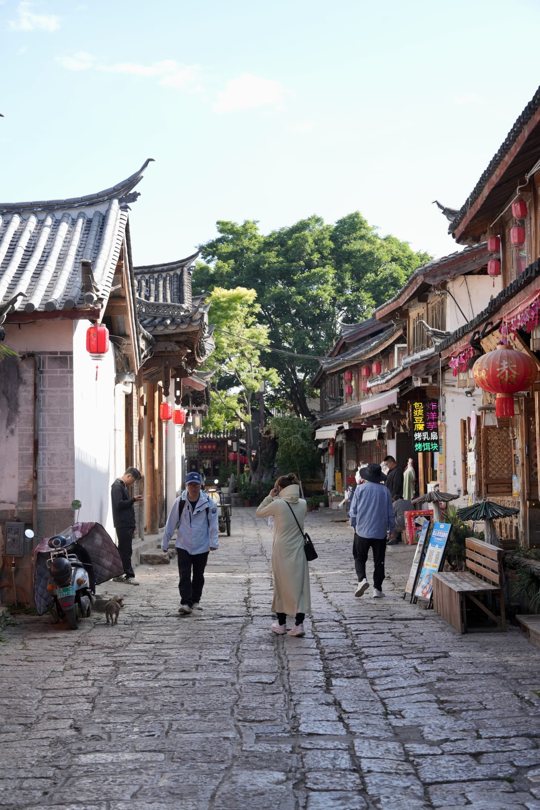 A quiet cobbled lane in Shuhe old town at morning light, Naxi architecture and red lanterns