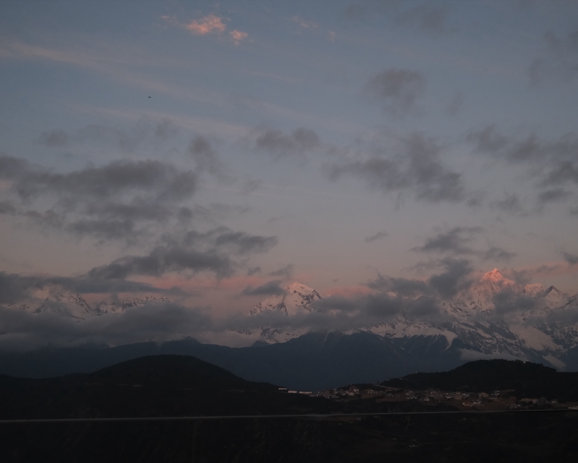 Sunrise alpenglow on Kawagarbo from Feilai Si, April 2026 — the moment the trip pivots on