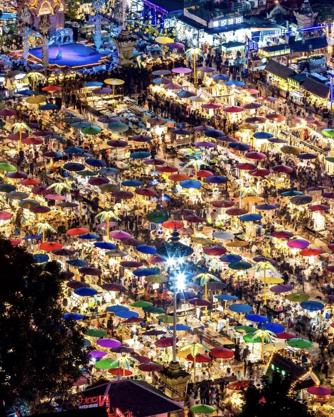 Jinghong night market with colourful parasols from above, Xishuangbanna