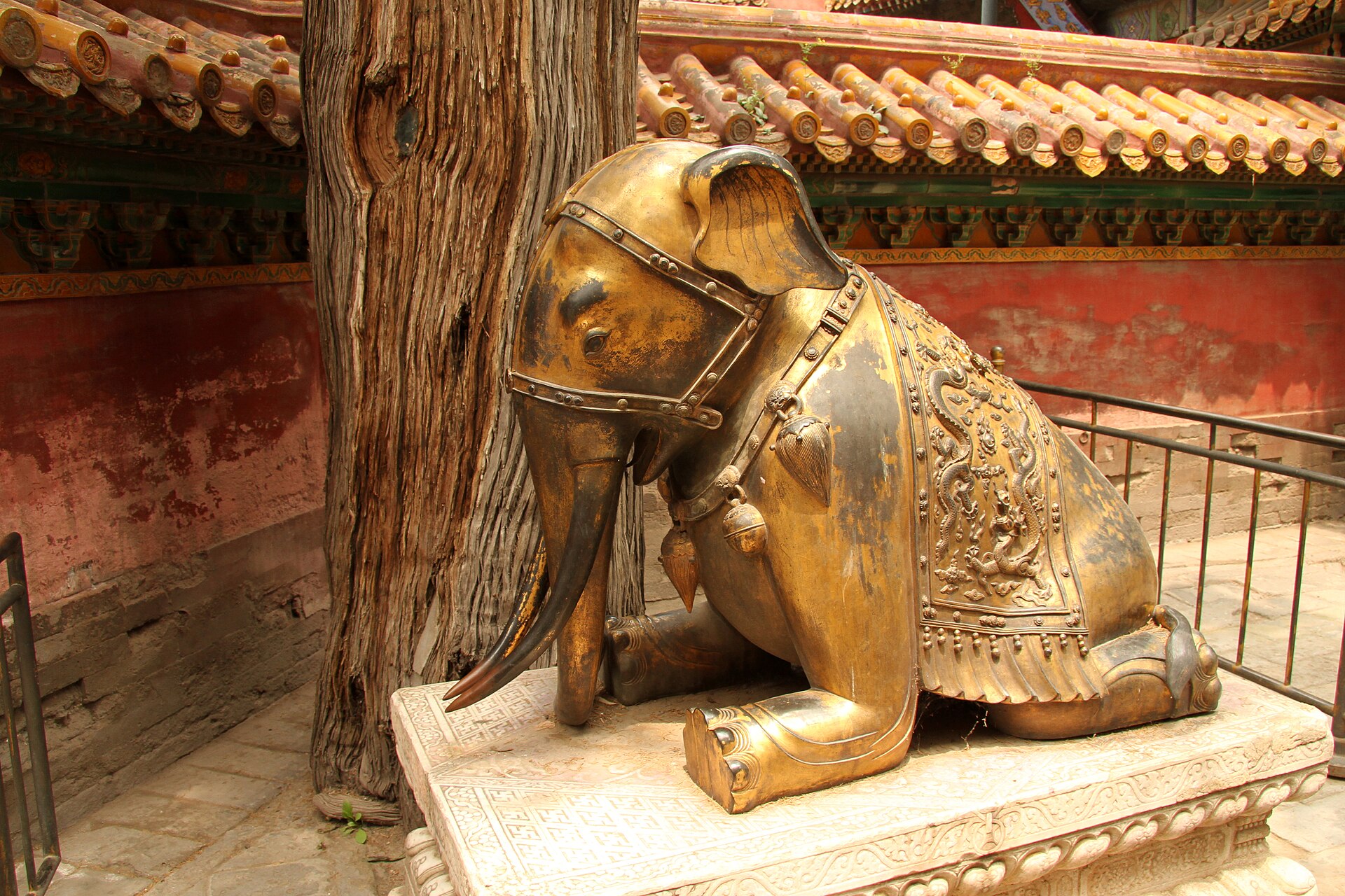 A kneeling gilt-bronze elephant beside the Imperial Garden (御花园) gate inside the Forbidden City (故宫), Beijing
