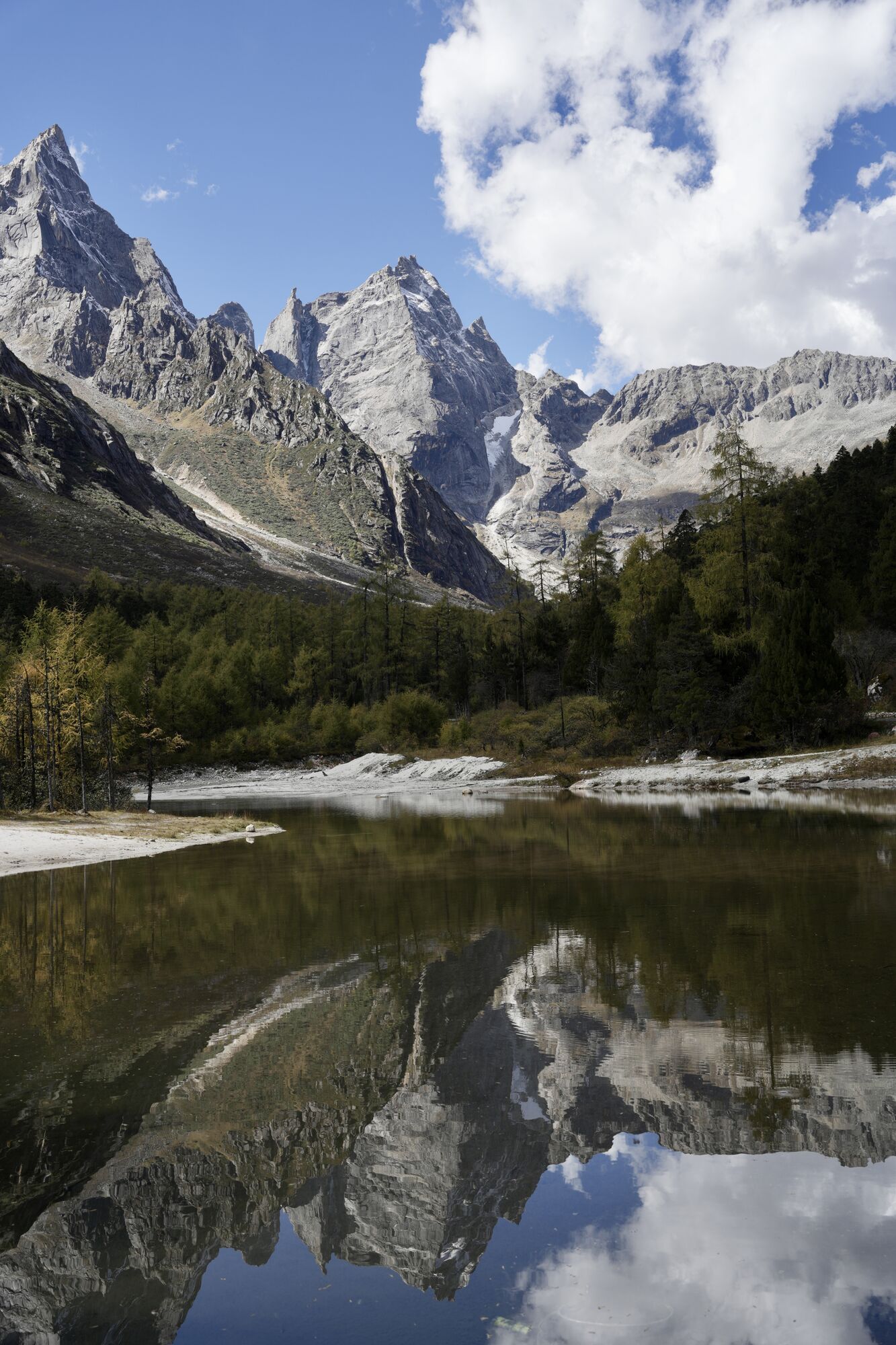 Sharp Bipeng peaks reflected in a glacial mirror lake — late Day 3