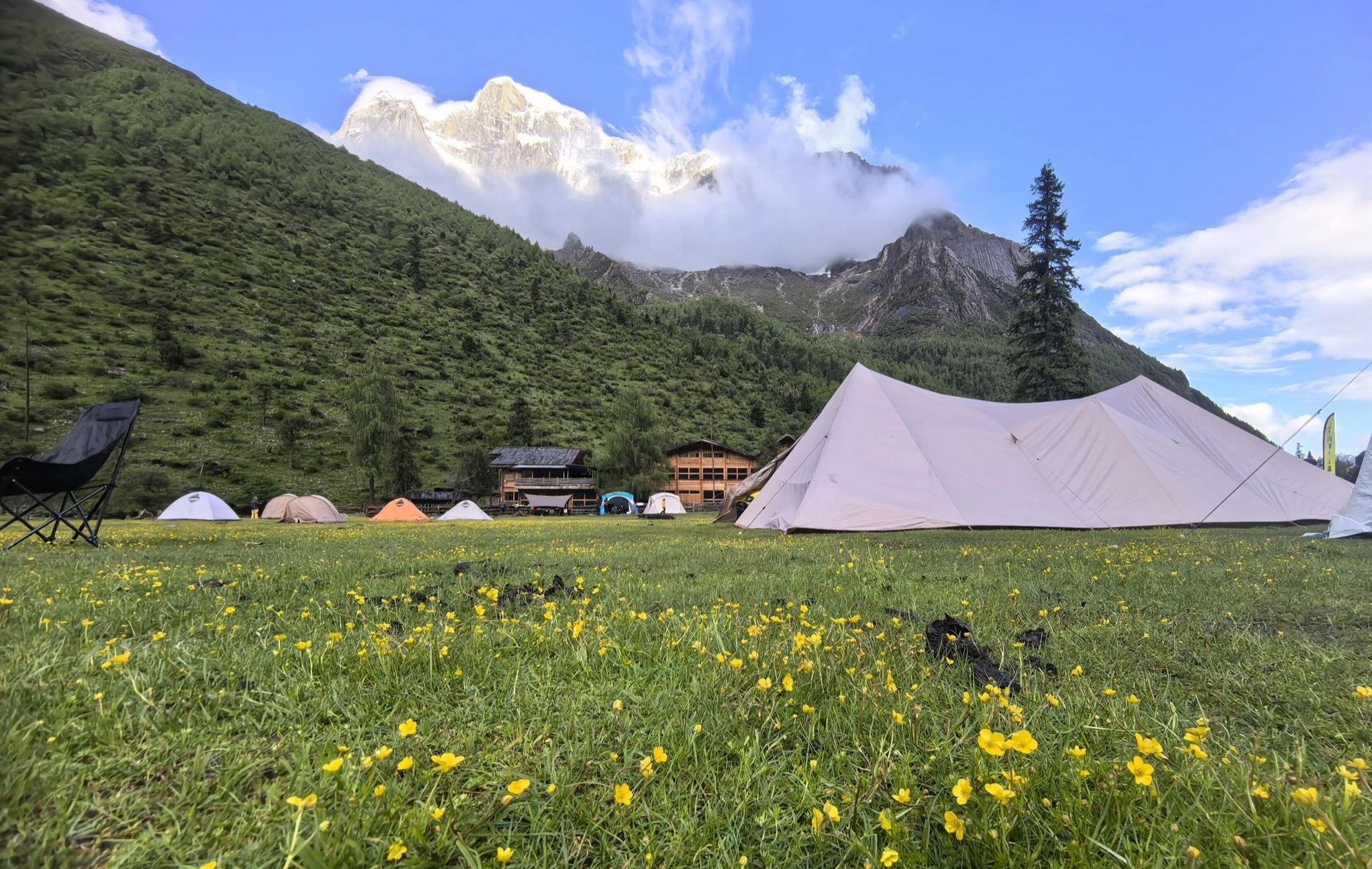 Alpine camp with tents and wildflowers on the Changping–Bipeng traverse