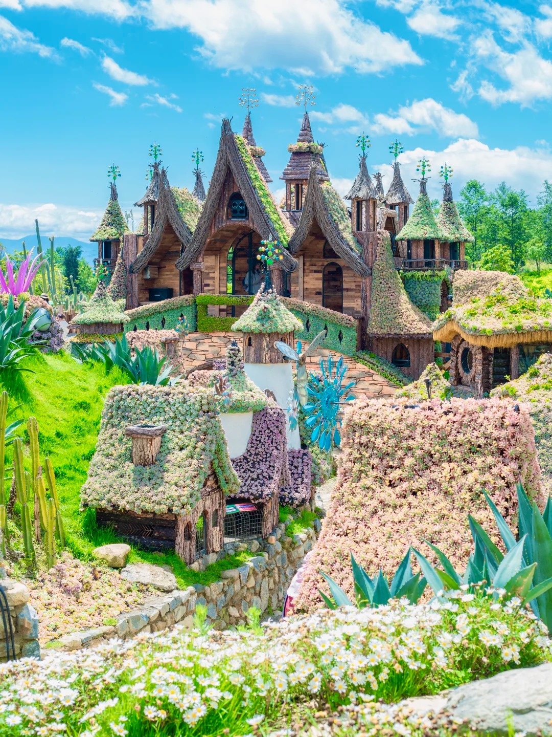 Succulent-roofed fairytale-village houses at Dali's Cloud Succulent Garden — the kids call it the fairy town. Hero image for the Dali Family Fairytale trip by Boutique China