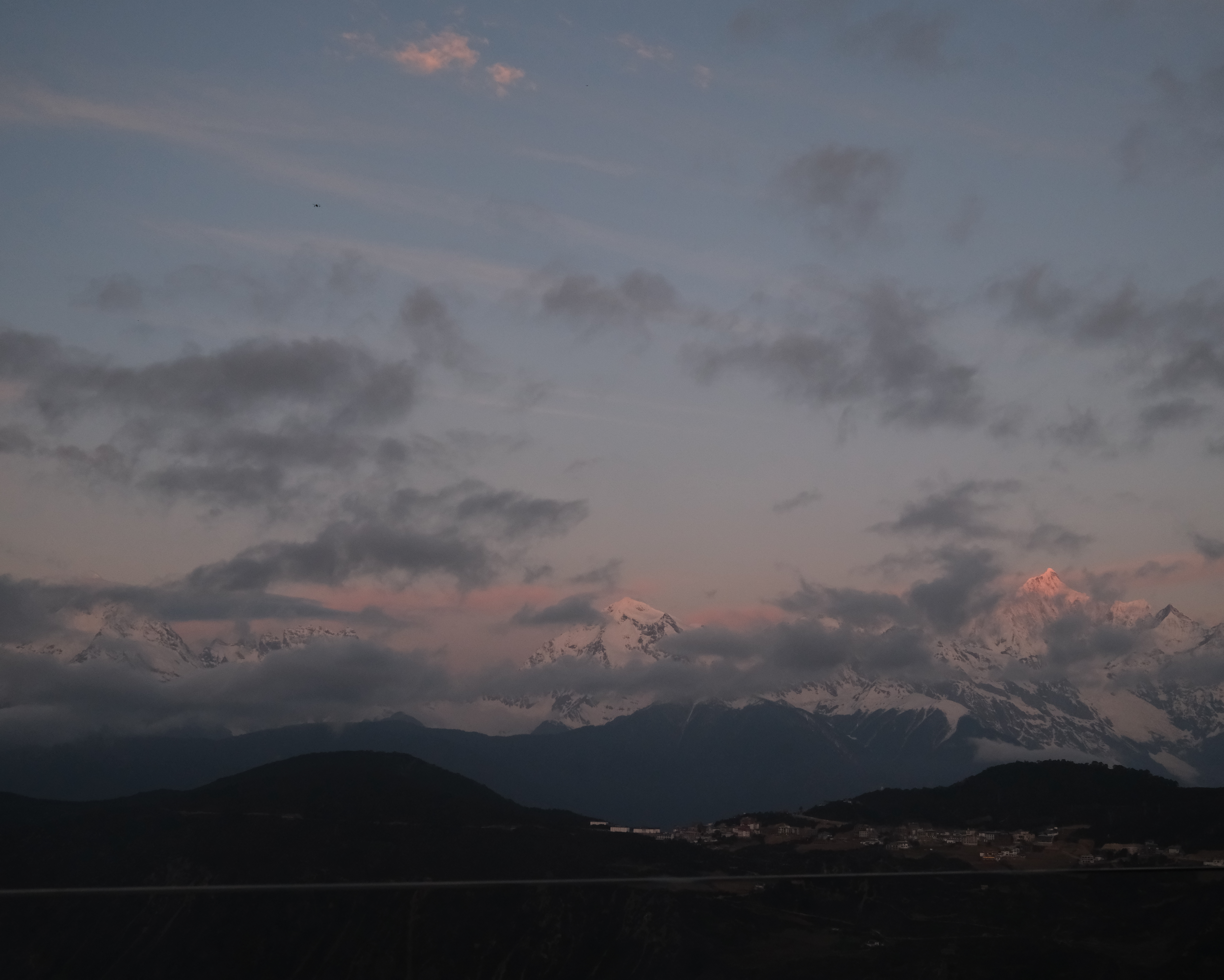 Pink alpenglow on Kawagebo's main peak at first light, seen from the Feilai Si platform