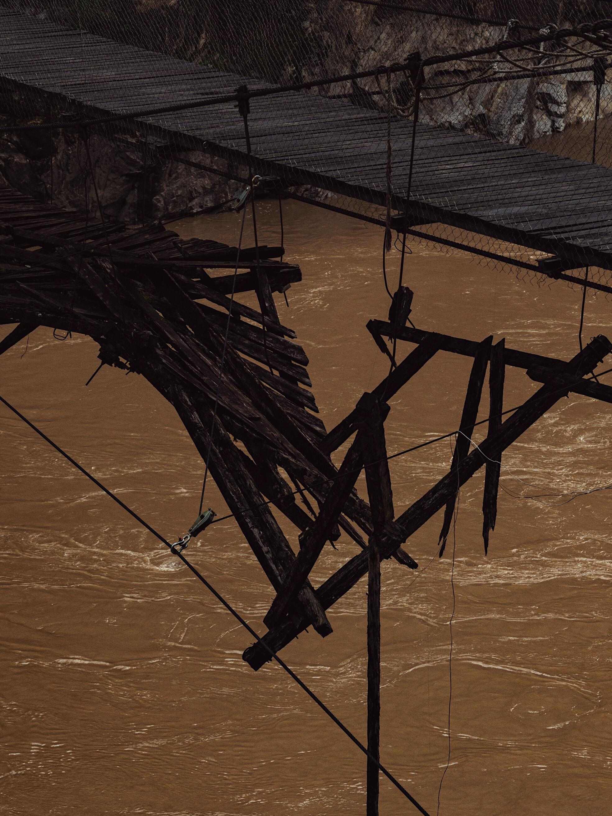 Old wooden footbridge in a Mekong-side gorge village — China's Last Frontier loop