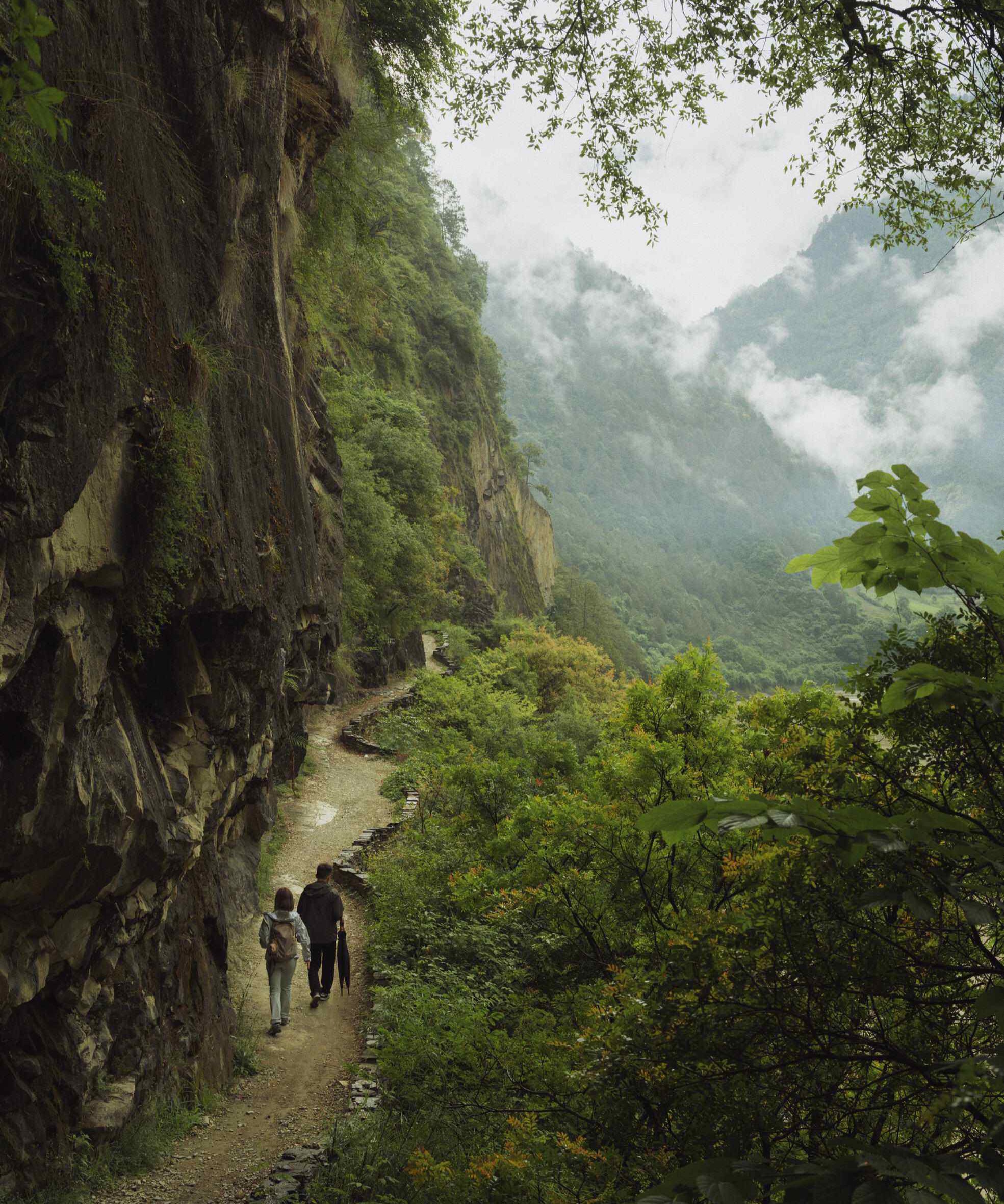 Hikers on the Wuli Tea Horse Road cliff trail high above the Nujiang/Salween River — China's Last Frontier loop