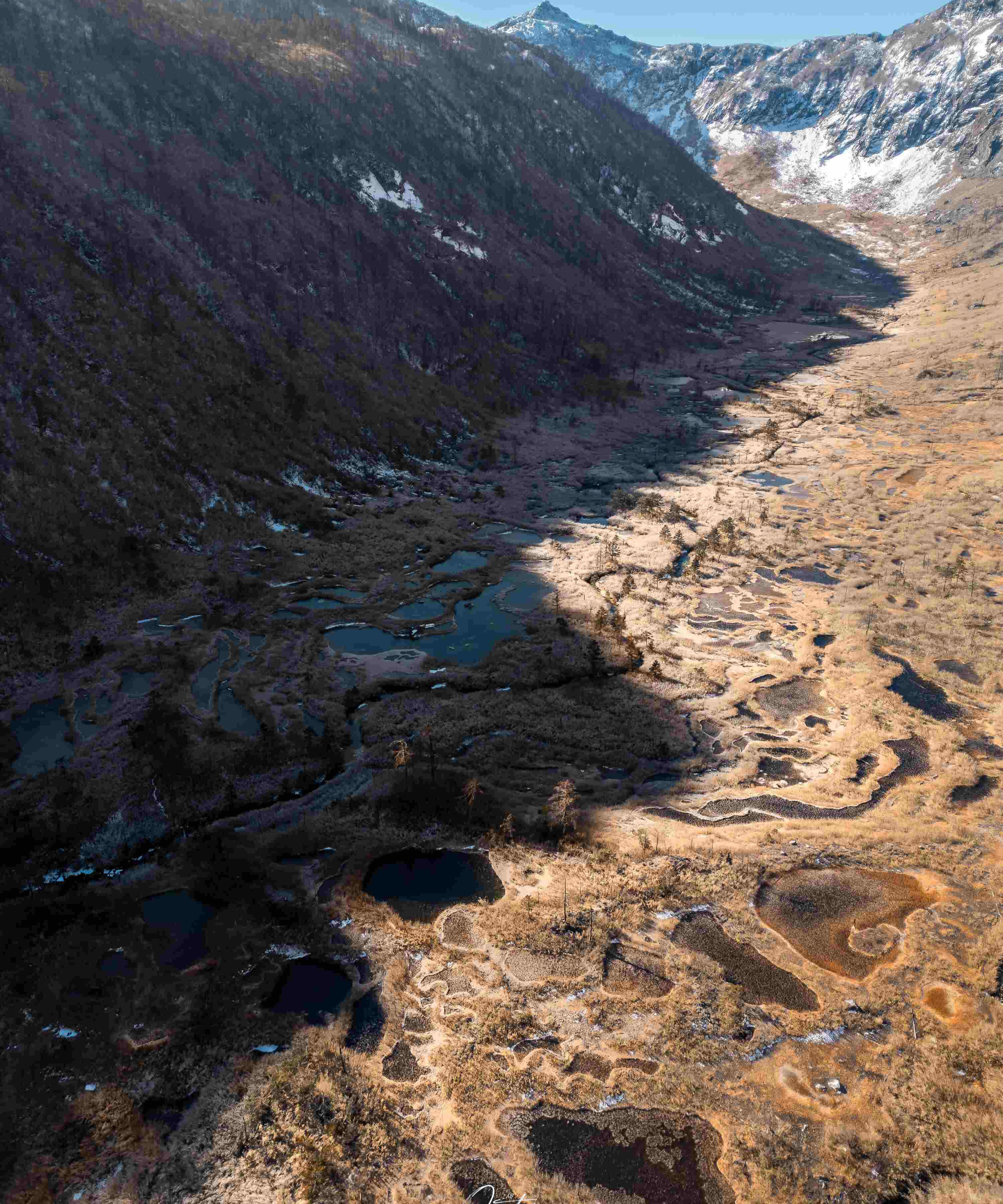 Aerial view of alpine limestone terrace pools above the Nujiang region — China's Last Frontier loop