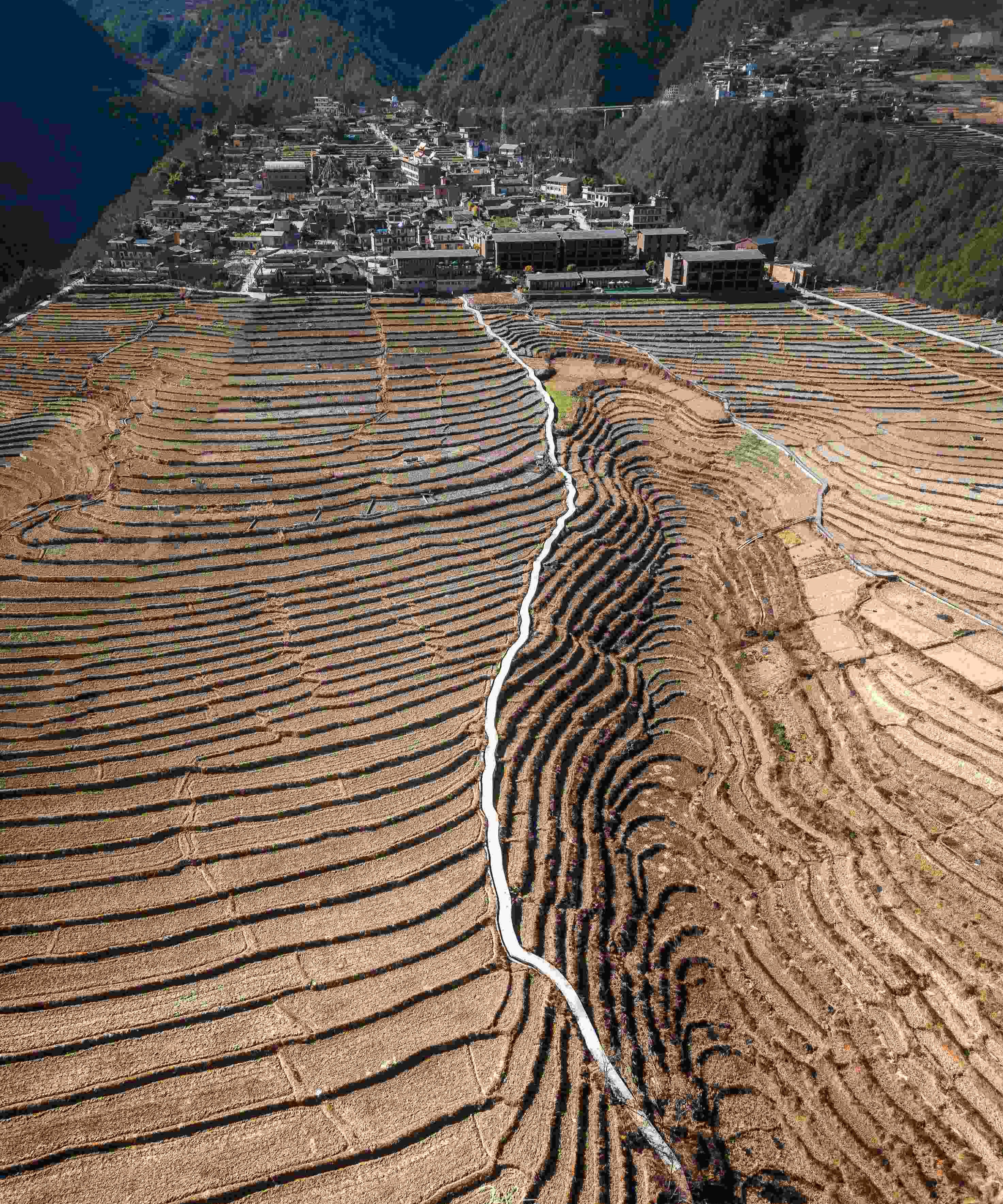 Terraced fields and a frontier village stepped into the gorge slope — China's Last Frontier loop