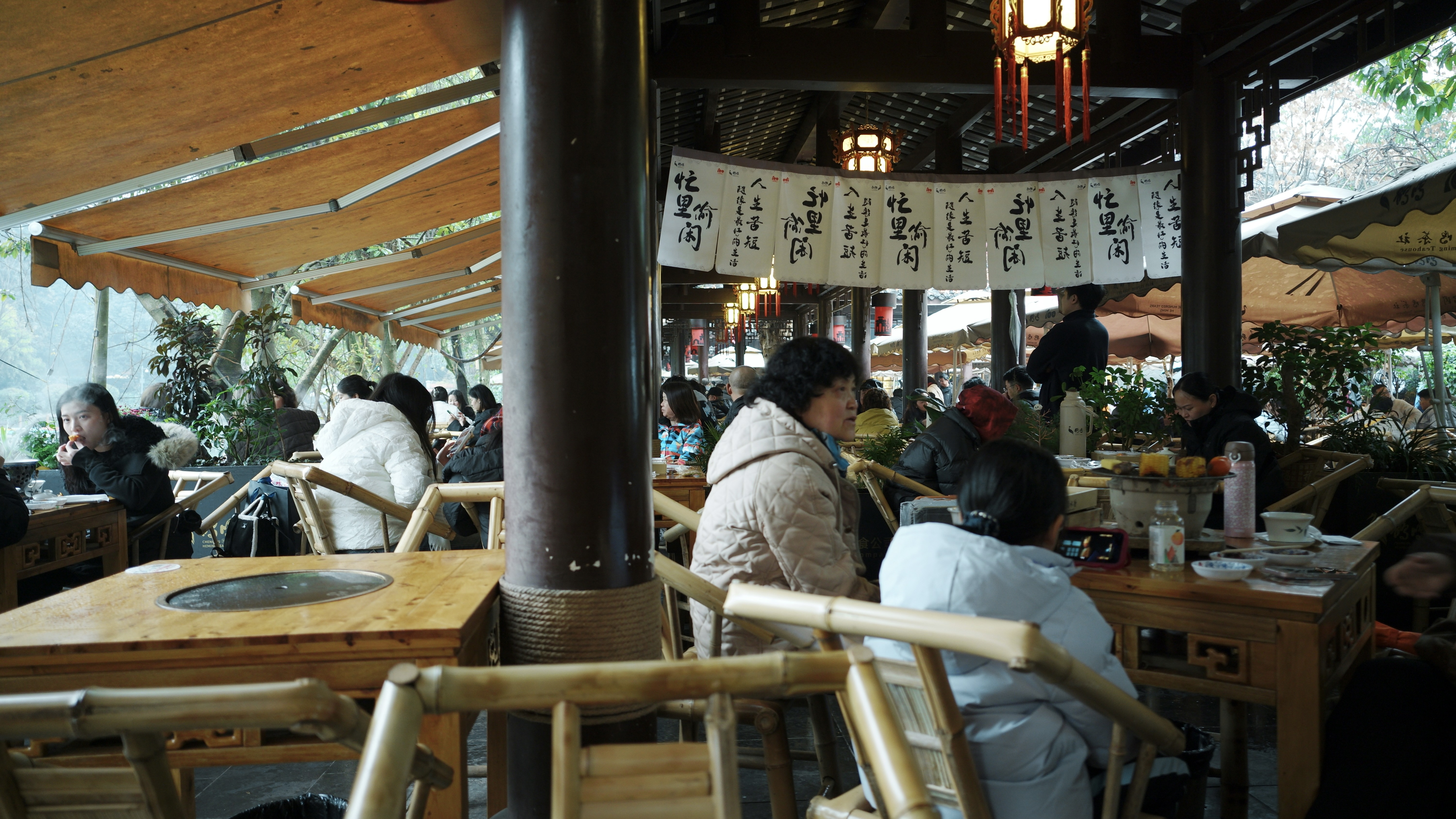 Locals sipping tea in bamboo chairs at a traditional Chengdu teahouse — the slow afternoon before the Chongqing leg