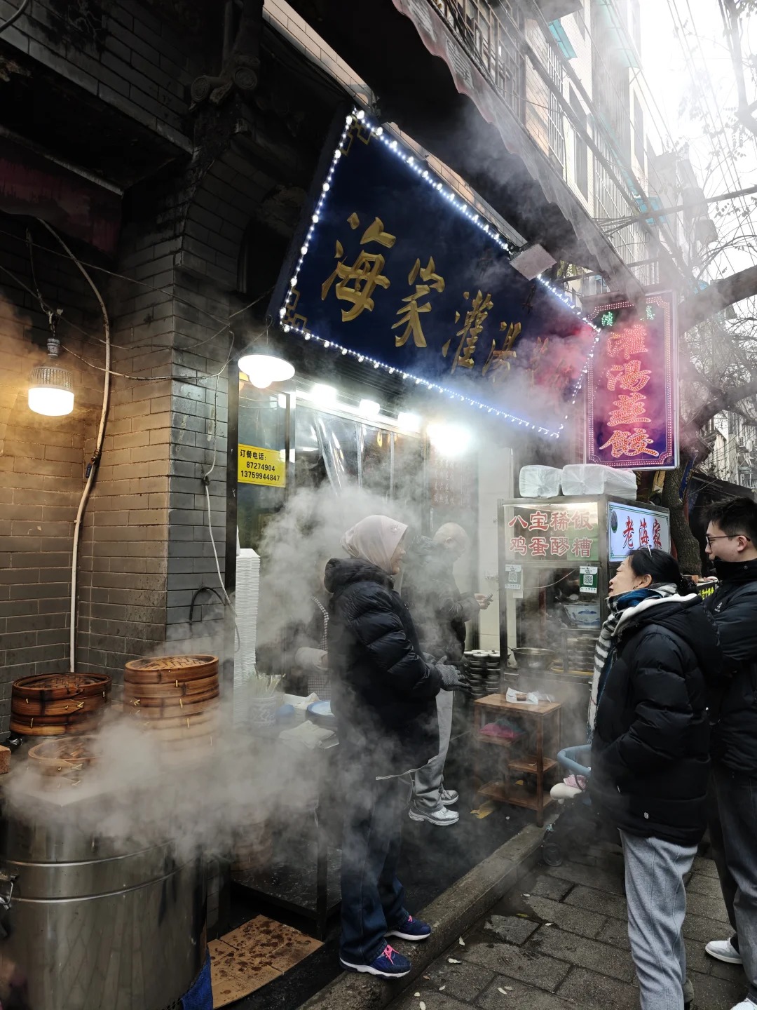 Steam rising from street-food stalls in Xi'an's Muslim Quarter at night — Classic China tour