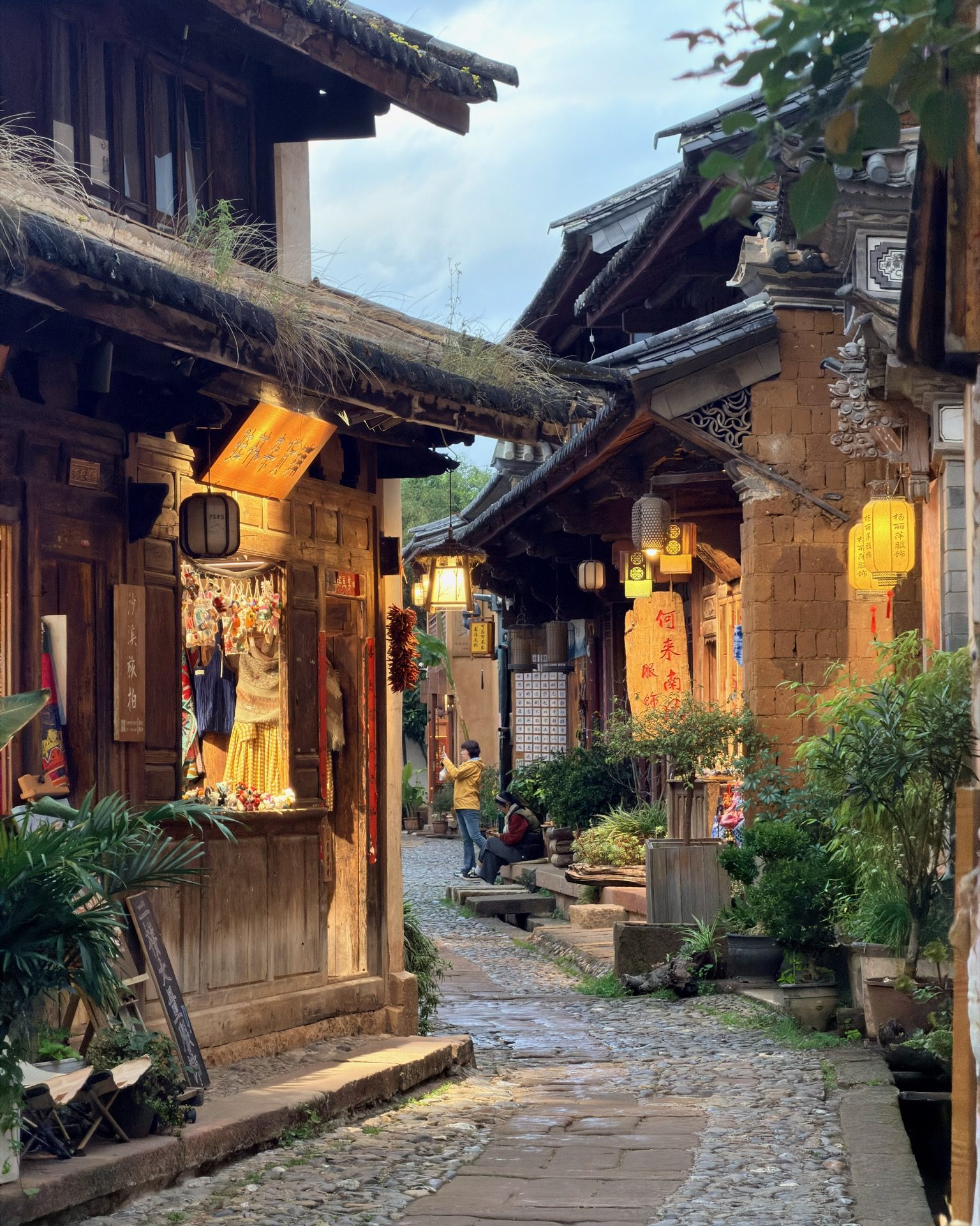 Lantern shop illuminating a narrow evening alley in Shaxi
