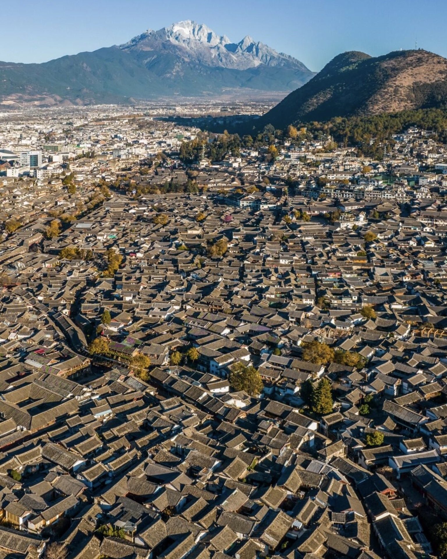 Aerial view of Lijiang Old Town's rooftop tapestry — the trip's final view from the air