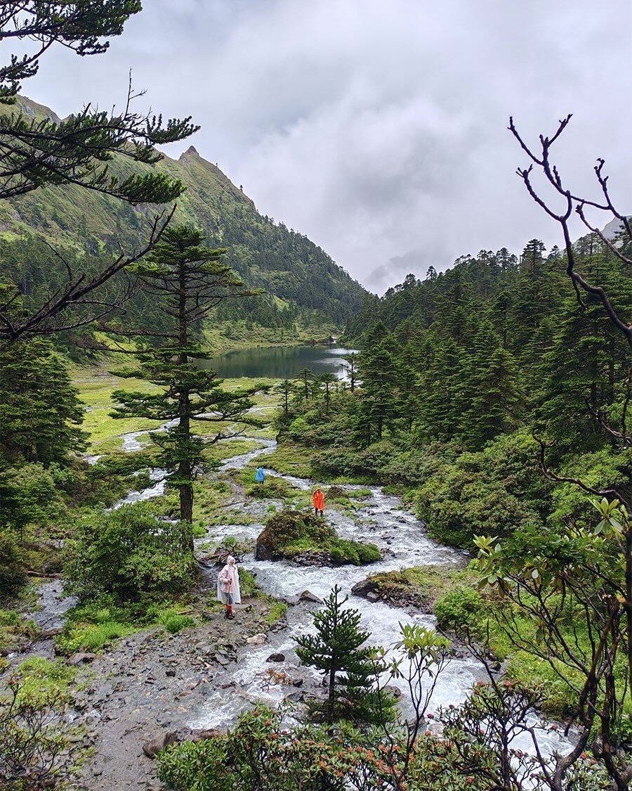 Alpine meadow and stream below the Meili Snow Mountain ridge — China's Last Frontier loop