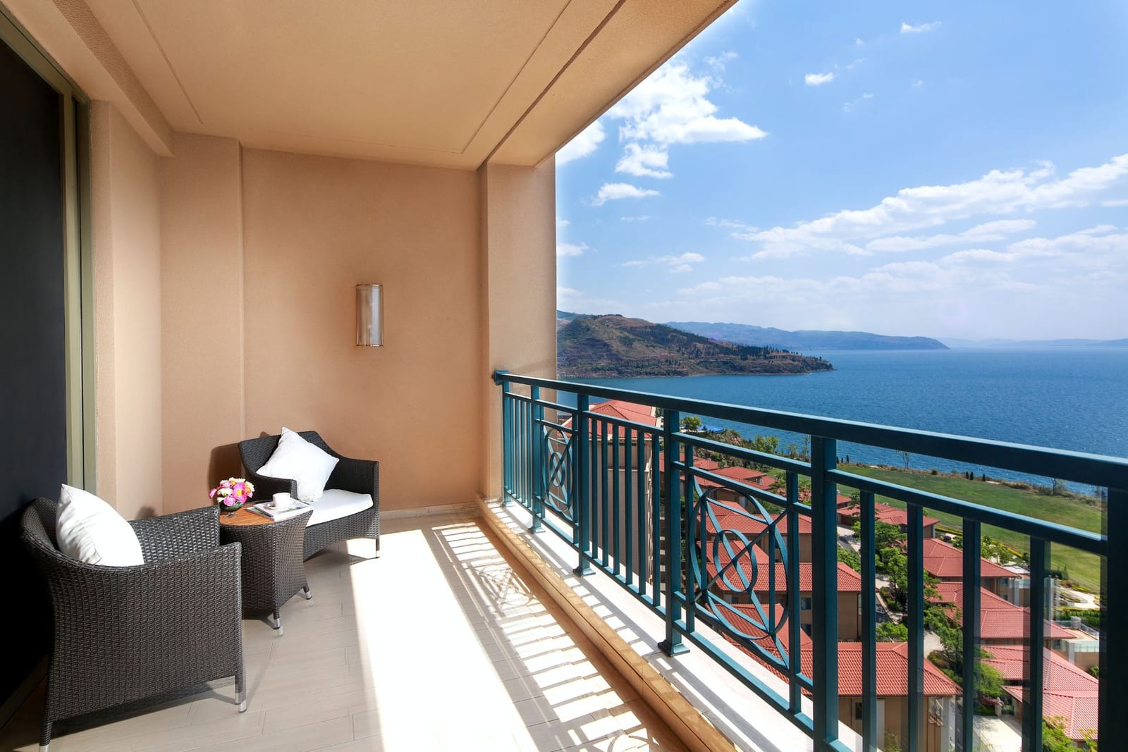 Hilton Yuxi Fuxian Lake — a balcony with wicker armchairs looking out over Fuxian Lake and the headlands of the east shore