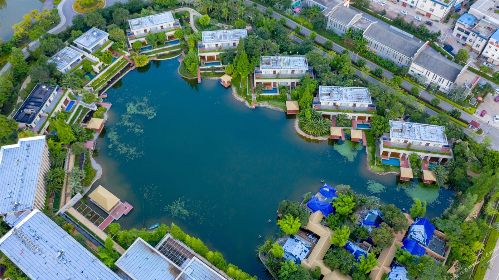 Wanda Vista Yuxi Fuxian Lake from the air — villas and gardens set around the resort's lagoon