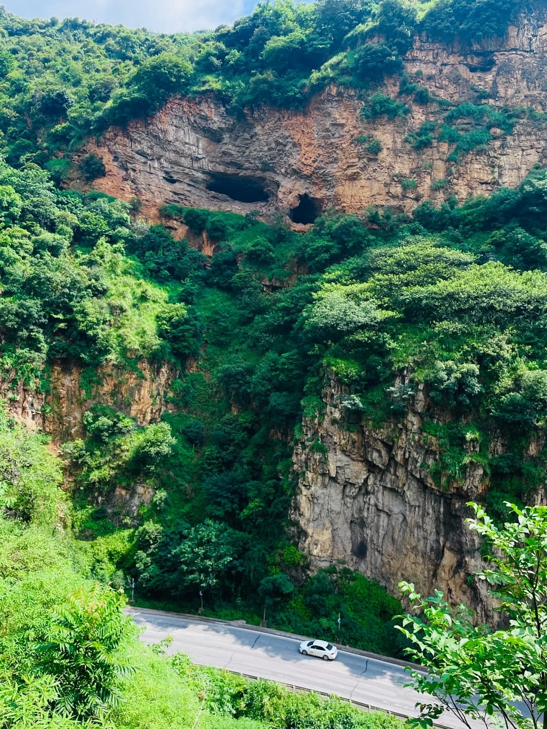 Limestone cliffs and caves above the valley beside the Yunnan–Vietnam Railway between Kebao and Yiliang