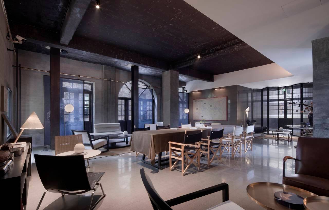 Alila Yangshuo — industrial-loft lounge inside the old mill with designer furniture and arched windows