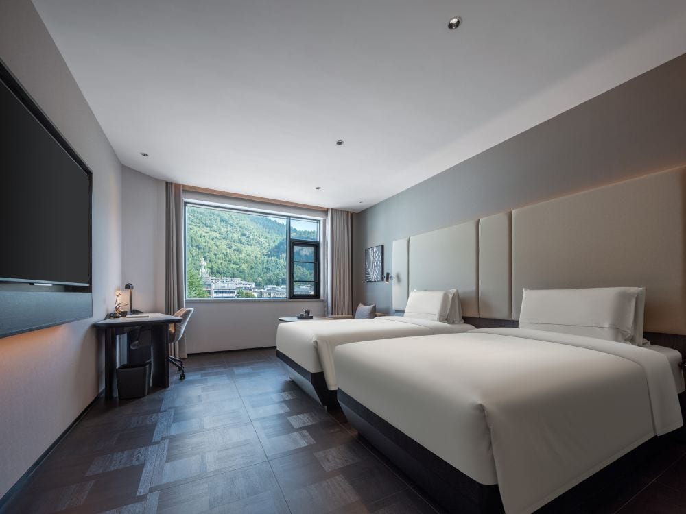 Atour Hotel, Zhangjiajie Forest Park Gate — a twin room with a window onto forested hillside
