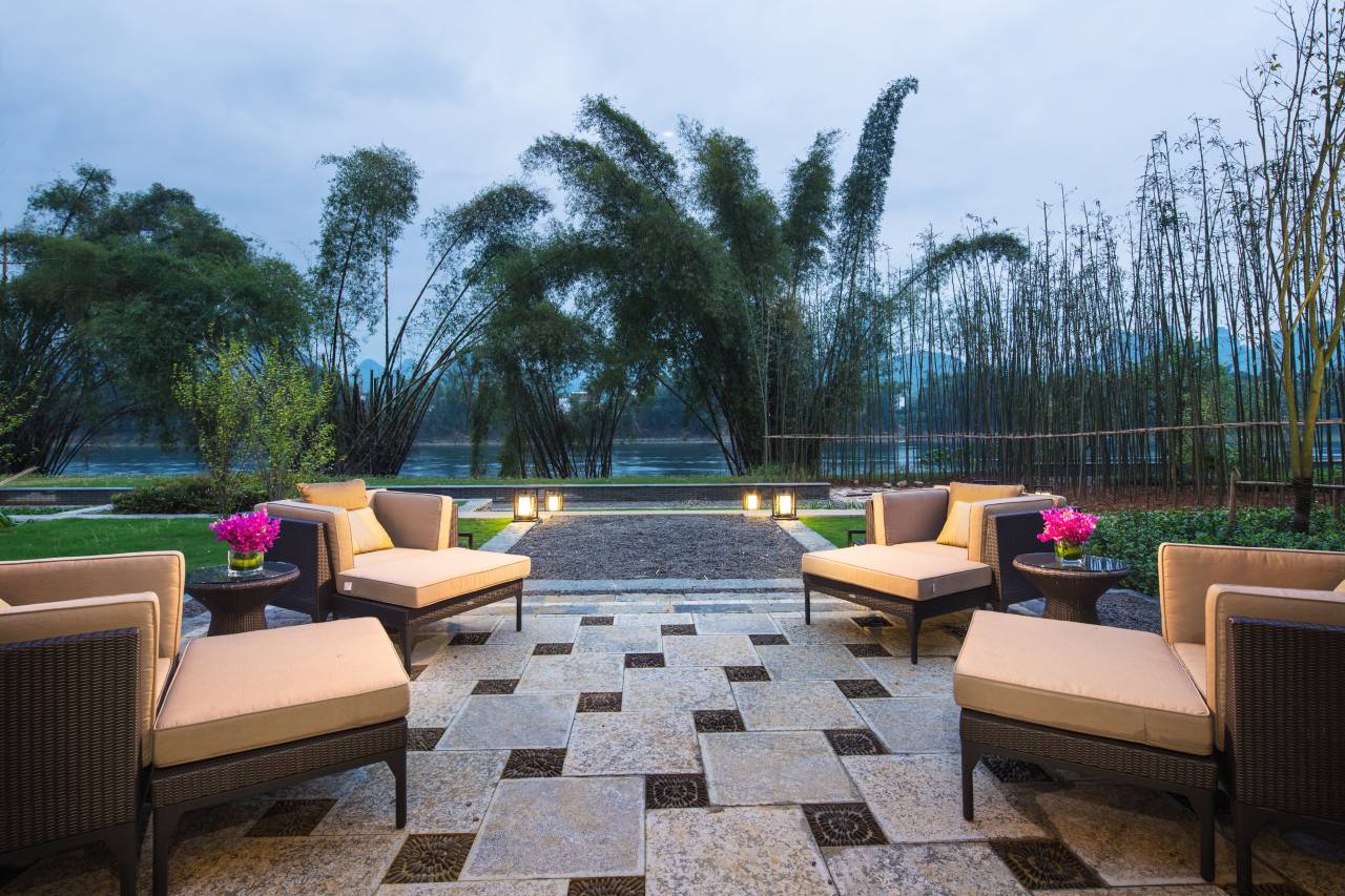 Banyan Tree Yangshuo — the outdoor pool deck at dusk