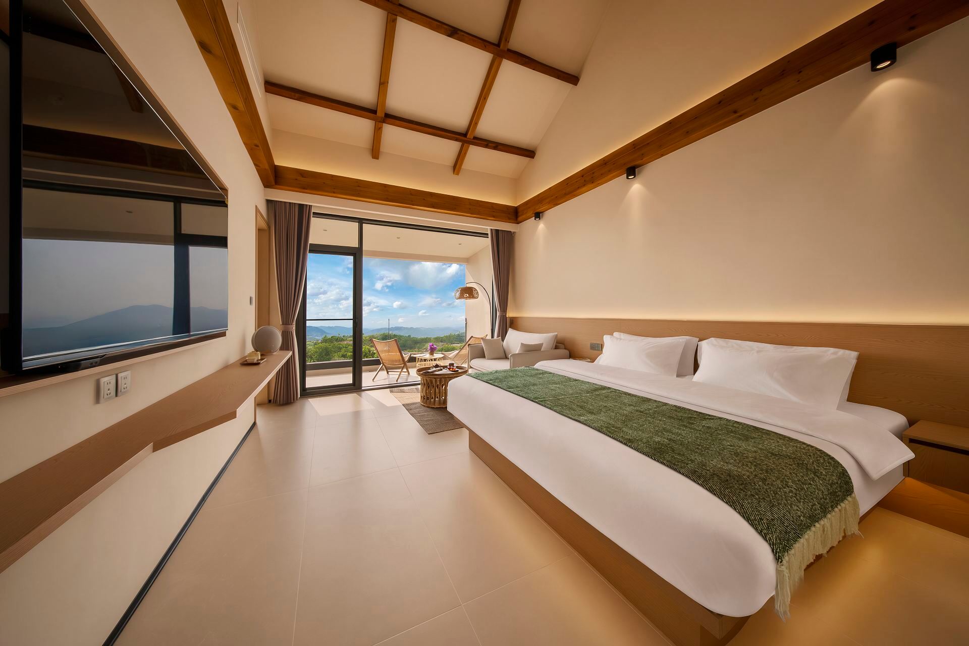 Bulang Yuni Inn — king guest room with vaulted timber ceiling and a terrace onto the tea mountains