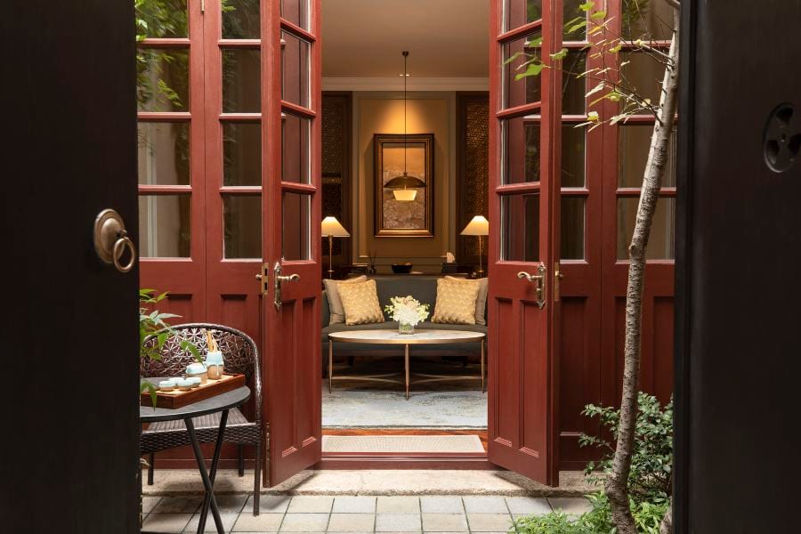 Capella Shanghai, Jian Ye Li (上海建业里嘉佩乐酒店) — a villa's private courtyard, red-lacquered French doors open to the living room