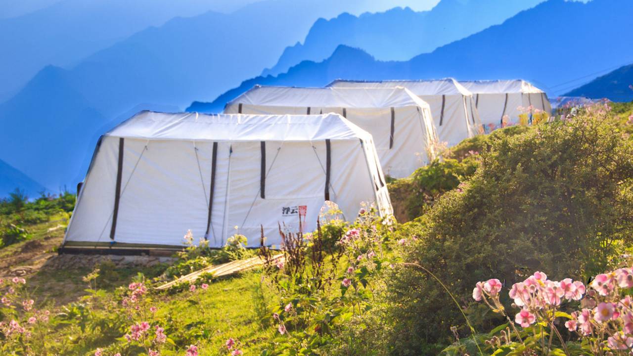 Fuyun Cloud Ranch — the signature white tent cabins on the alpine meadow ridge