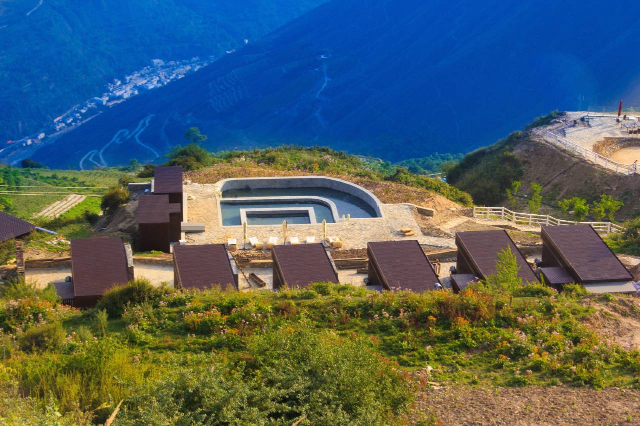 Fuyun Cloud Ranch — aerial of the ridge cabins and pool floating above the valley