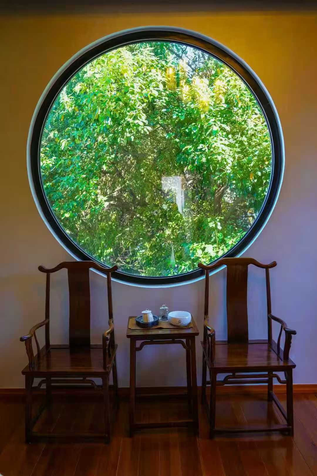 He Ting · Awamei — a moon window onto the garden, a pair of rosewood chairs below it