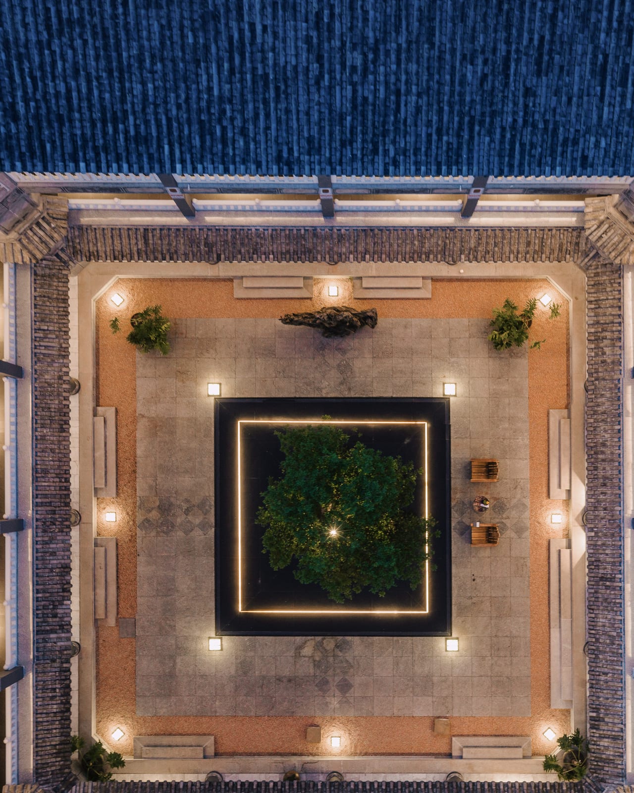 Kasion Erhai — the central courtyard seen from directly above, a planted square at its heart