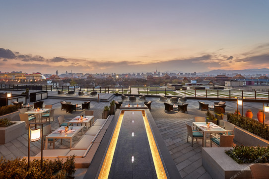 Mandarin Oriental Wangfujing, Beijing — the rooftop terrace at dusk over the lit city