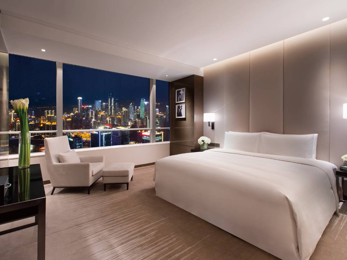 Niccolo Chongqing — guest room with floor-to-ceiling views over the Yuzhong night skyline