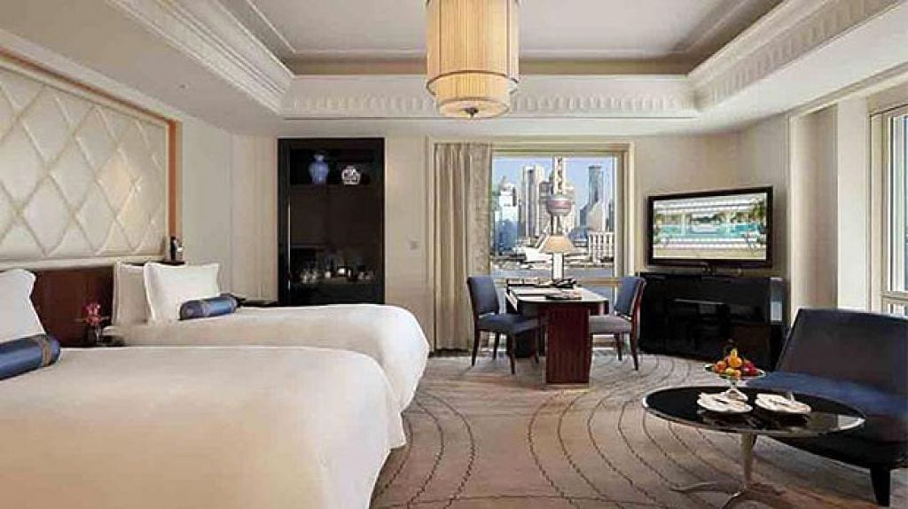 The Peninsula Shanghai — a twin room looking across the river to the Oriental Pearl Tower and Pudong