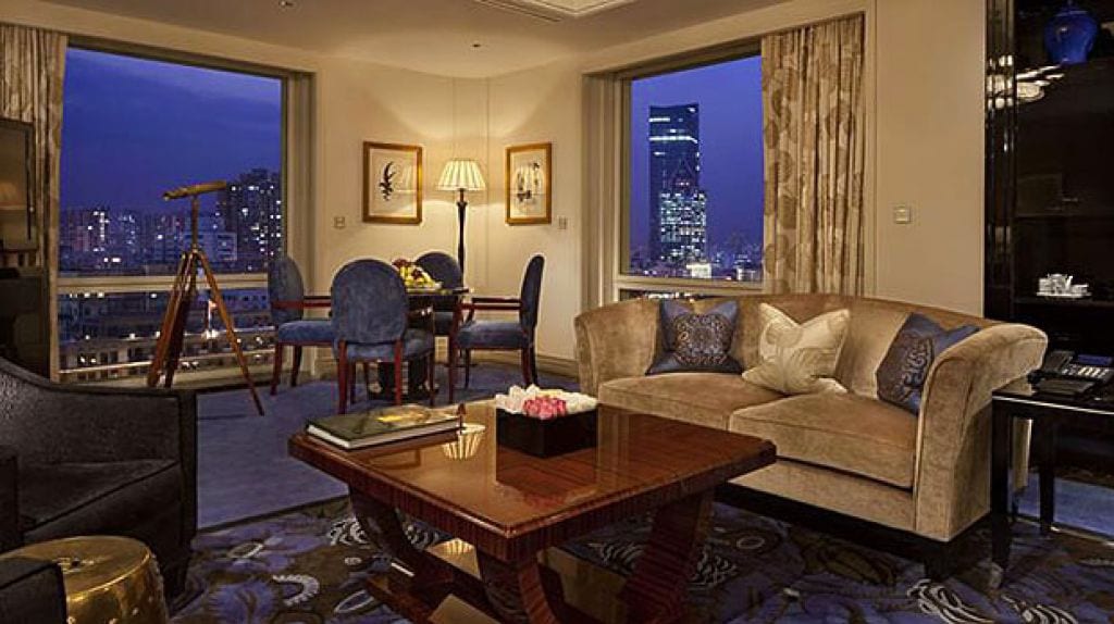 The Peninsula Shanghai — the living room of a Two-Bedroom Grand Deluxe River Suite at dusk