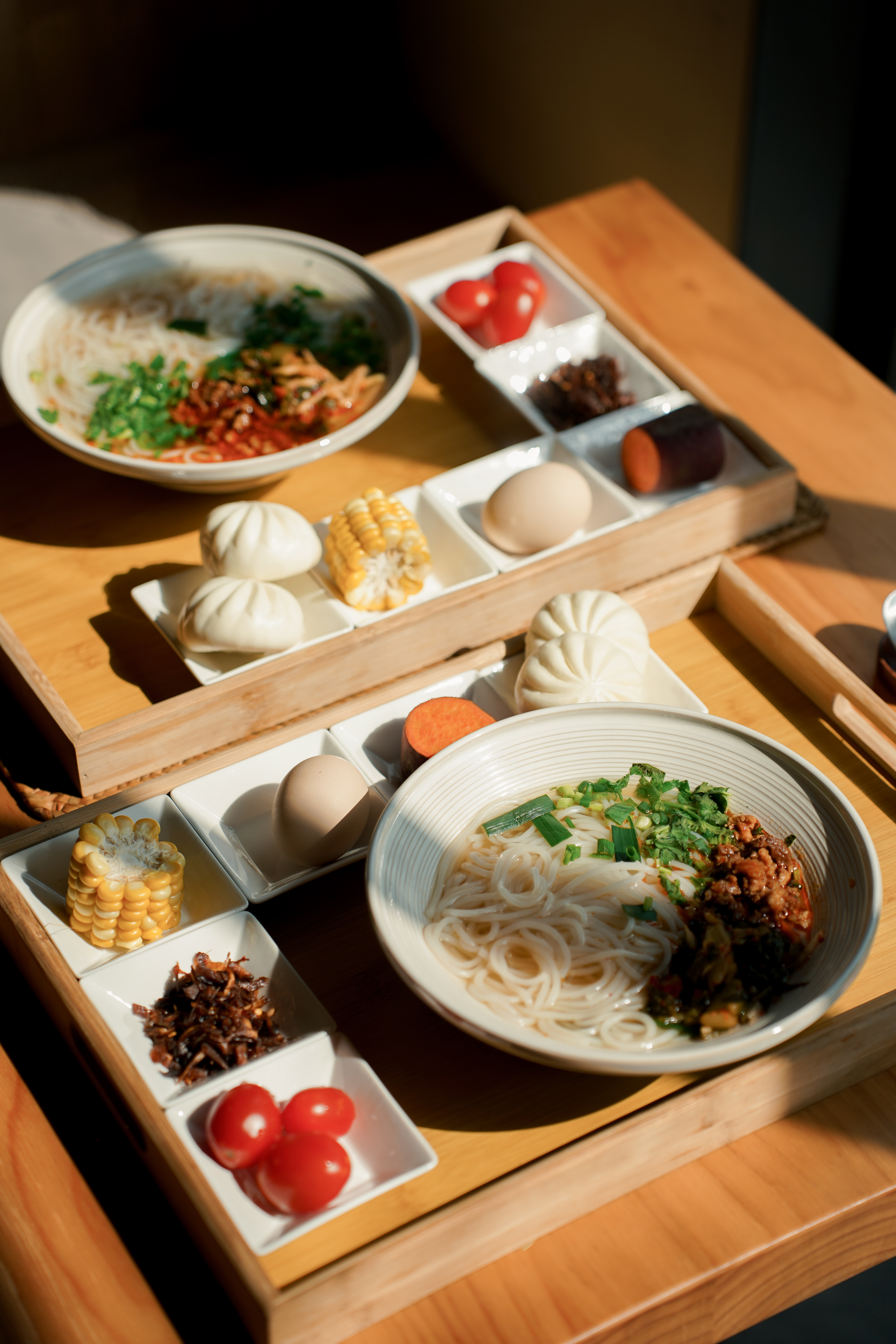 Porcelain Inn — Yunnan breakfast tray with rice noodles, baozi, and local sides
