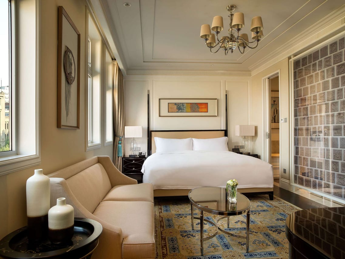 Sofitel Legend People's Grand Xi'an — a king room with tall windows and a chandelier above the bed