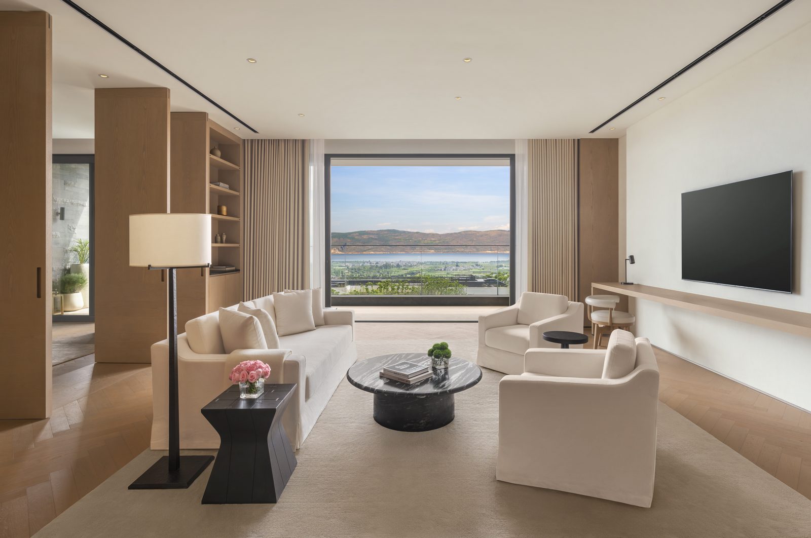 Lake-view suite living room at The Dali EDITION