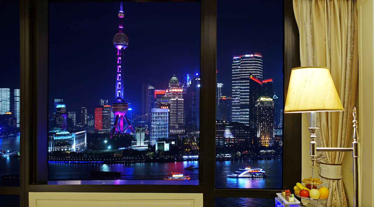 Waldorf Astoria Shanghai — a guest room framing the Pudong skyline at night