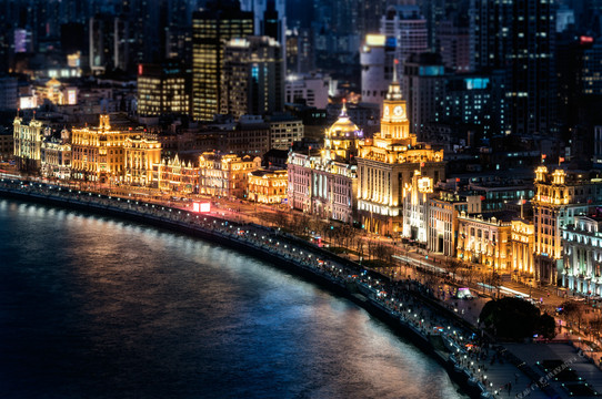 Waldorf Astoria Shanghai — the illuminated Bund banking row curving along the river at night