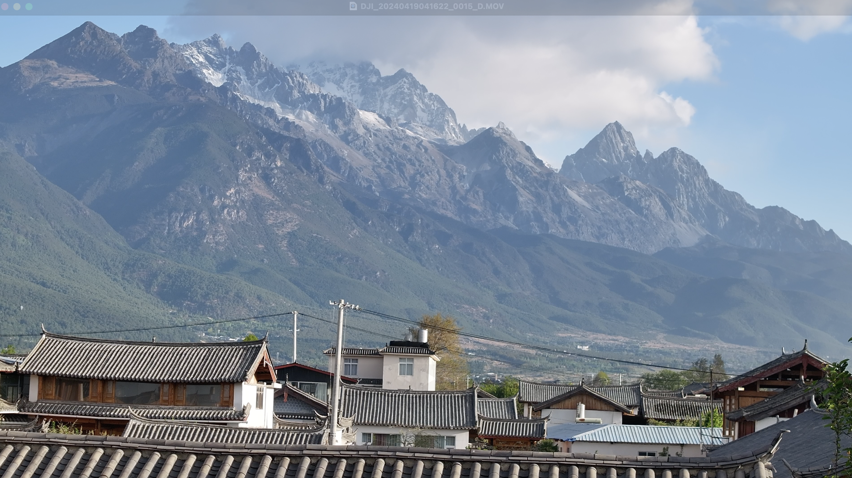 Jade Dragon Snow Mountain over Lijiang's old town rooftops