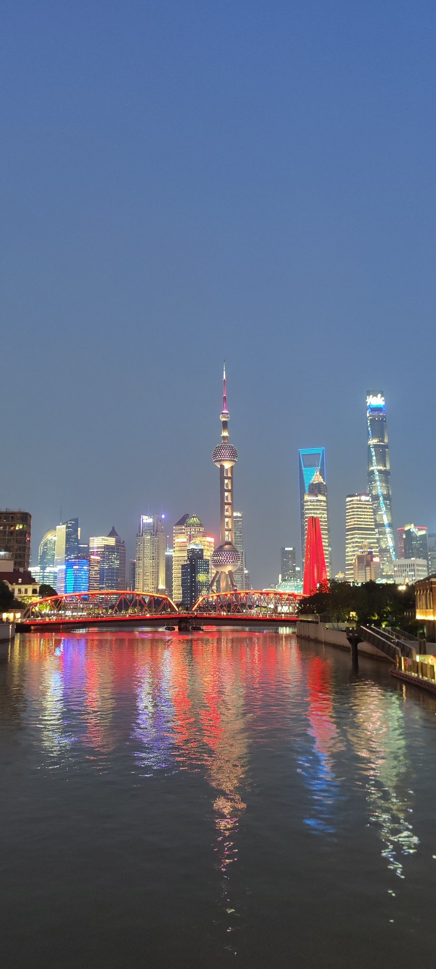 The Pudong skyline lit at dusk above the river, Shanghai