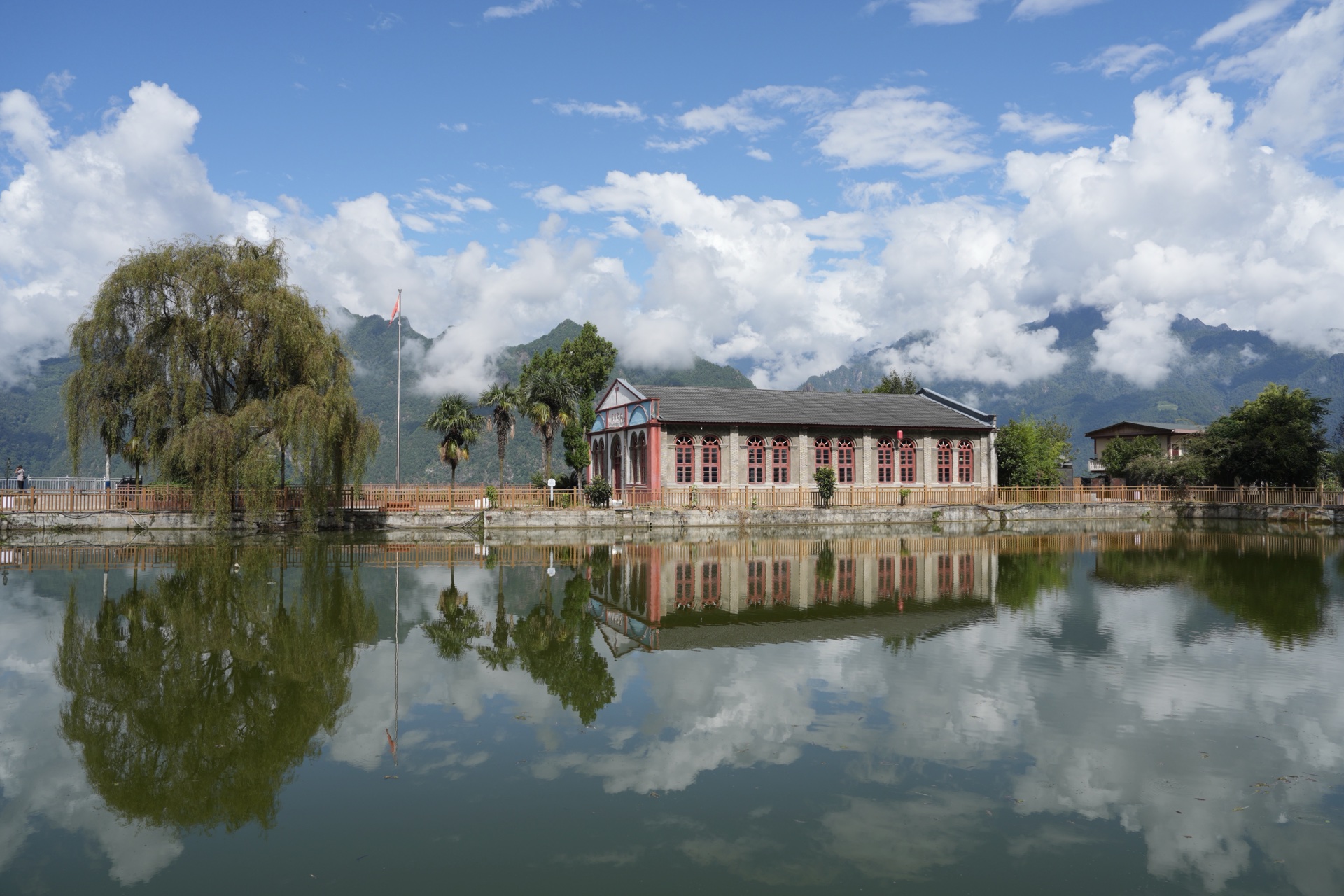 The church on its pond at Laomudeng, willow at the water's edge